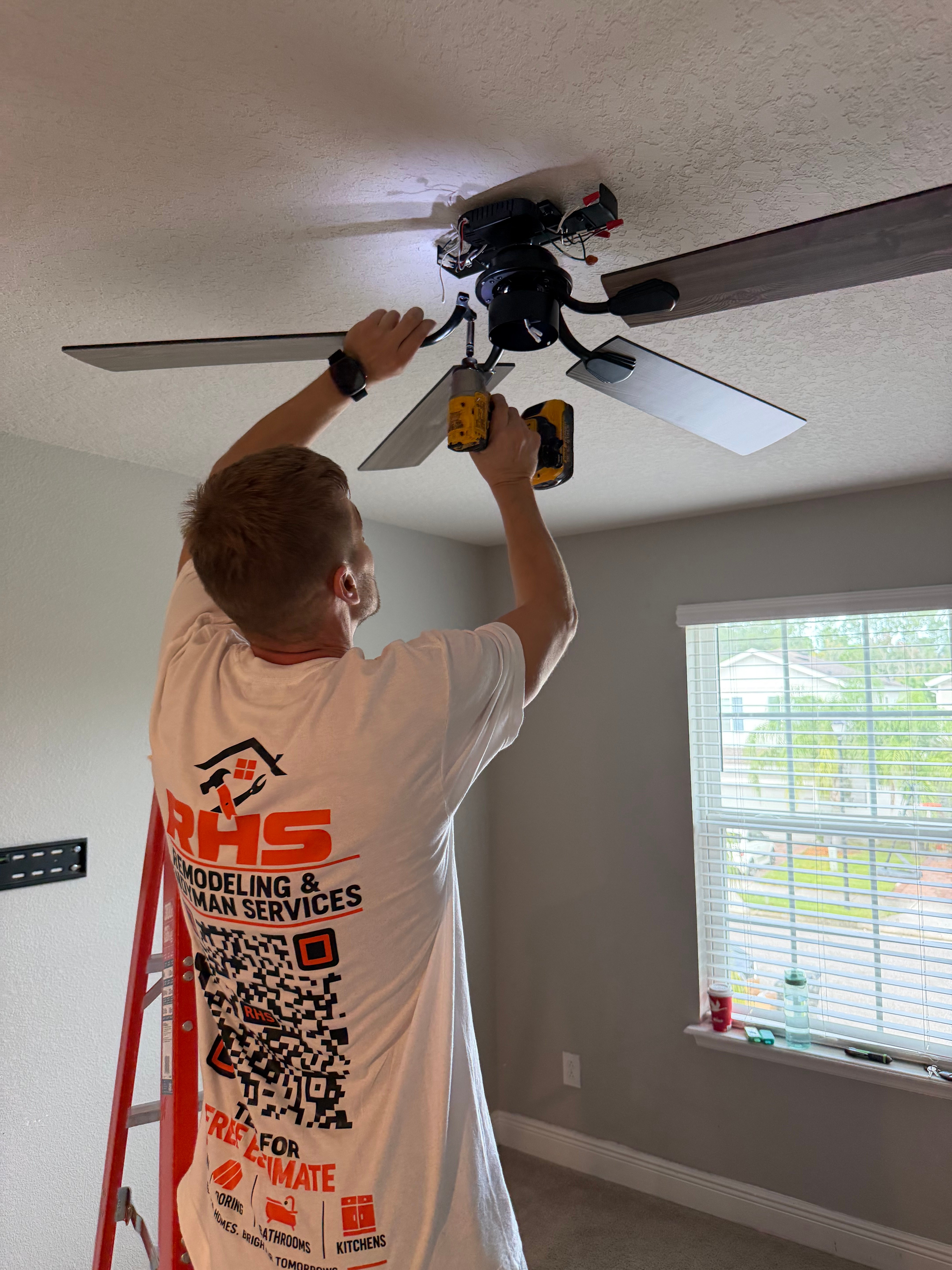 RHS Remodeling and Handyman Services professional installing a ceiling fan